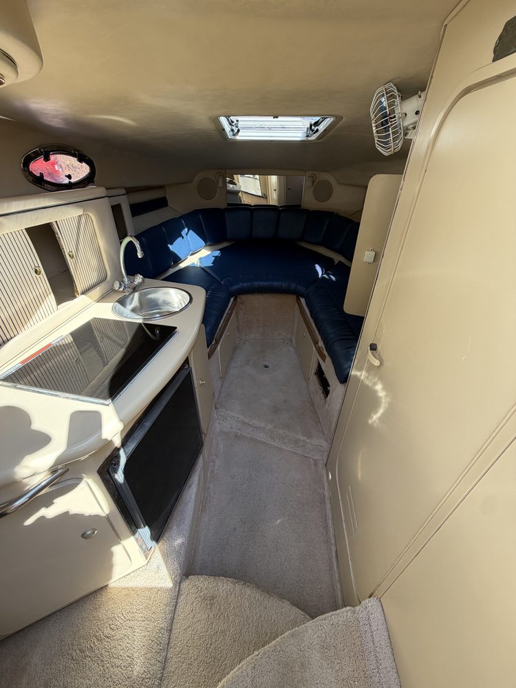 The same cuddy cabin with a clean ceiling, carpet and cushions