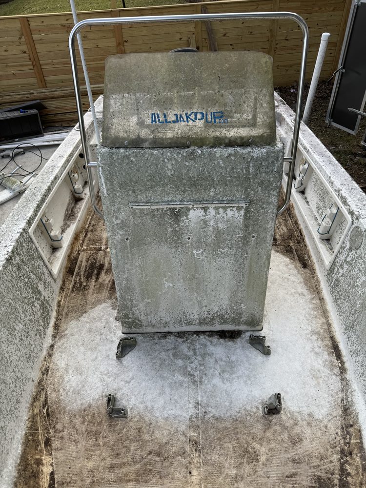 The console of the same boat covered in mildew, with a stained deck