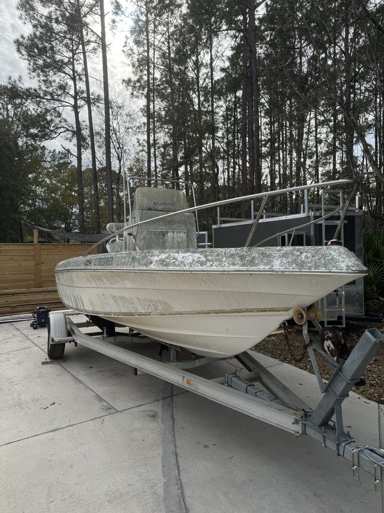 Center console on its trailer with mildew across the hull and deck