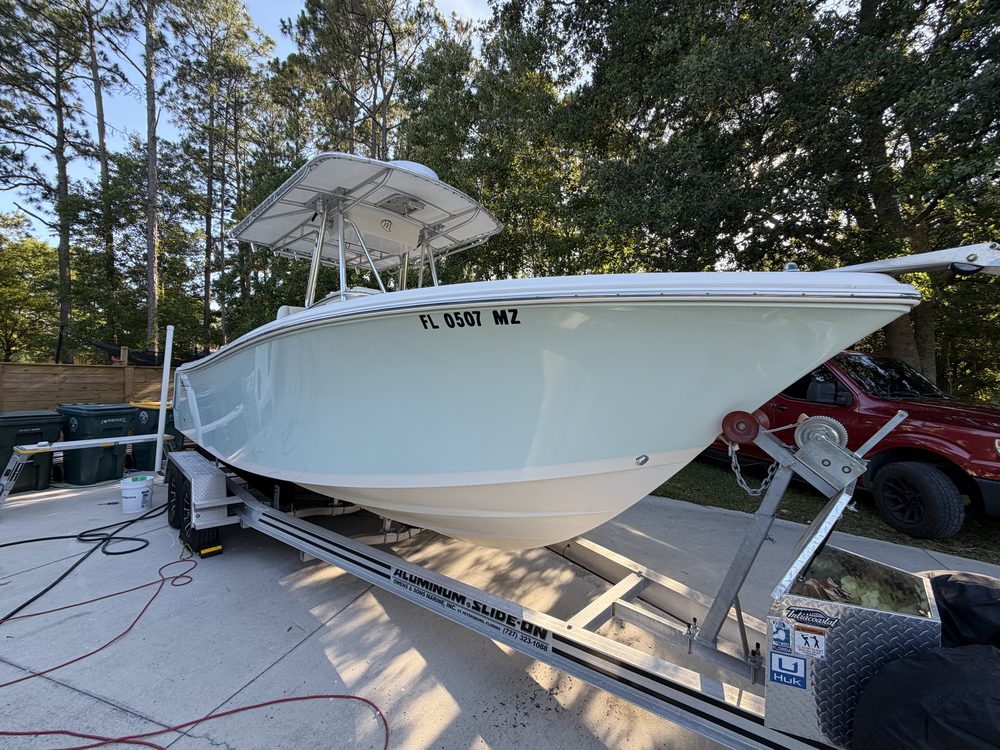 A light blue center console with a hardtop on its trailer