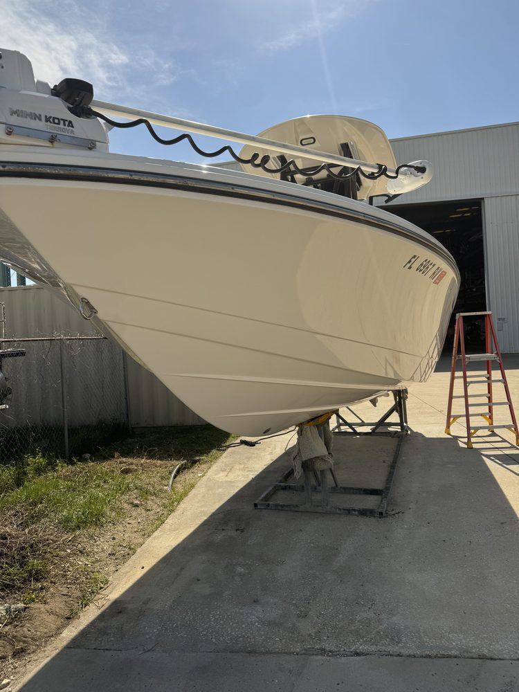 A white center console bow on stands after hull work