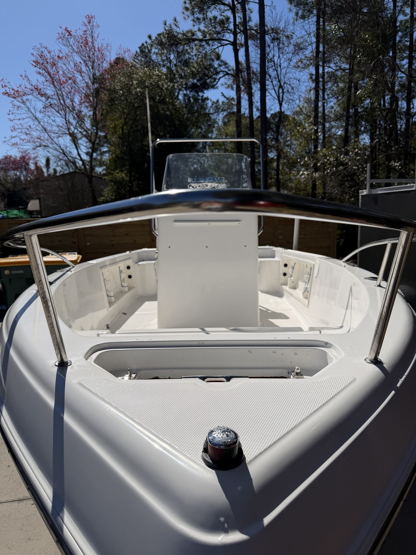 The same center console bow, clean and white, in the same driveway