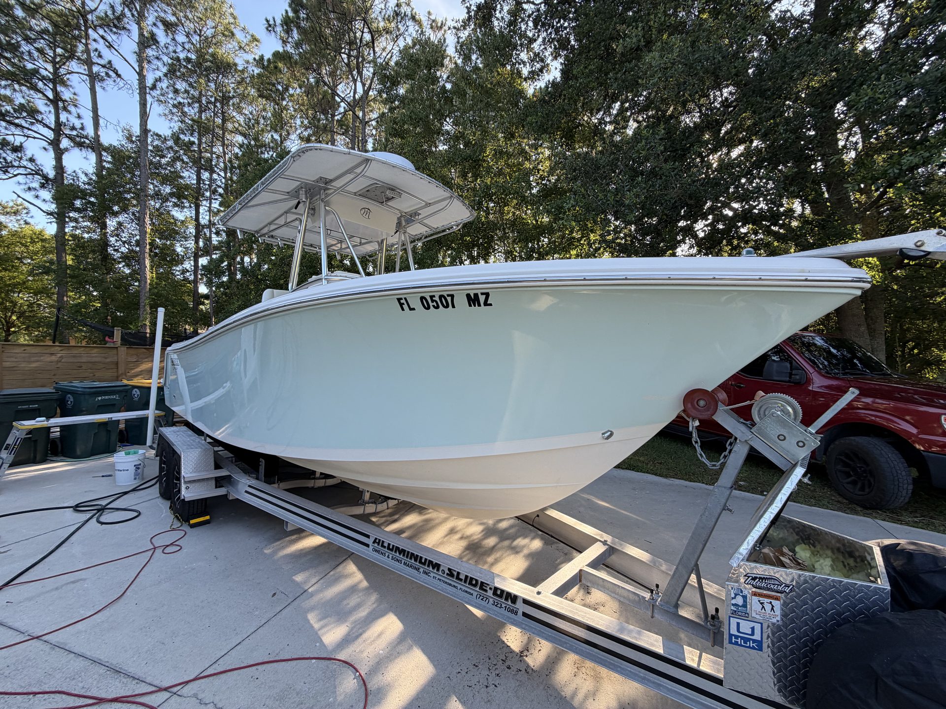 A light blue center console with a hardtop on its trailer