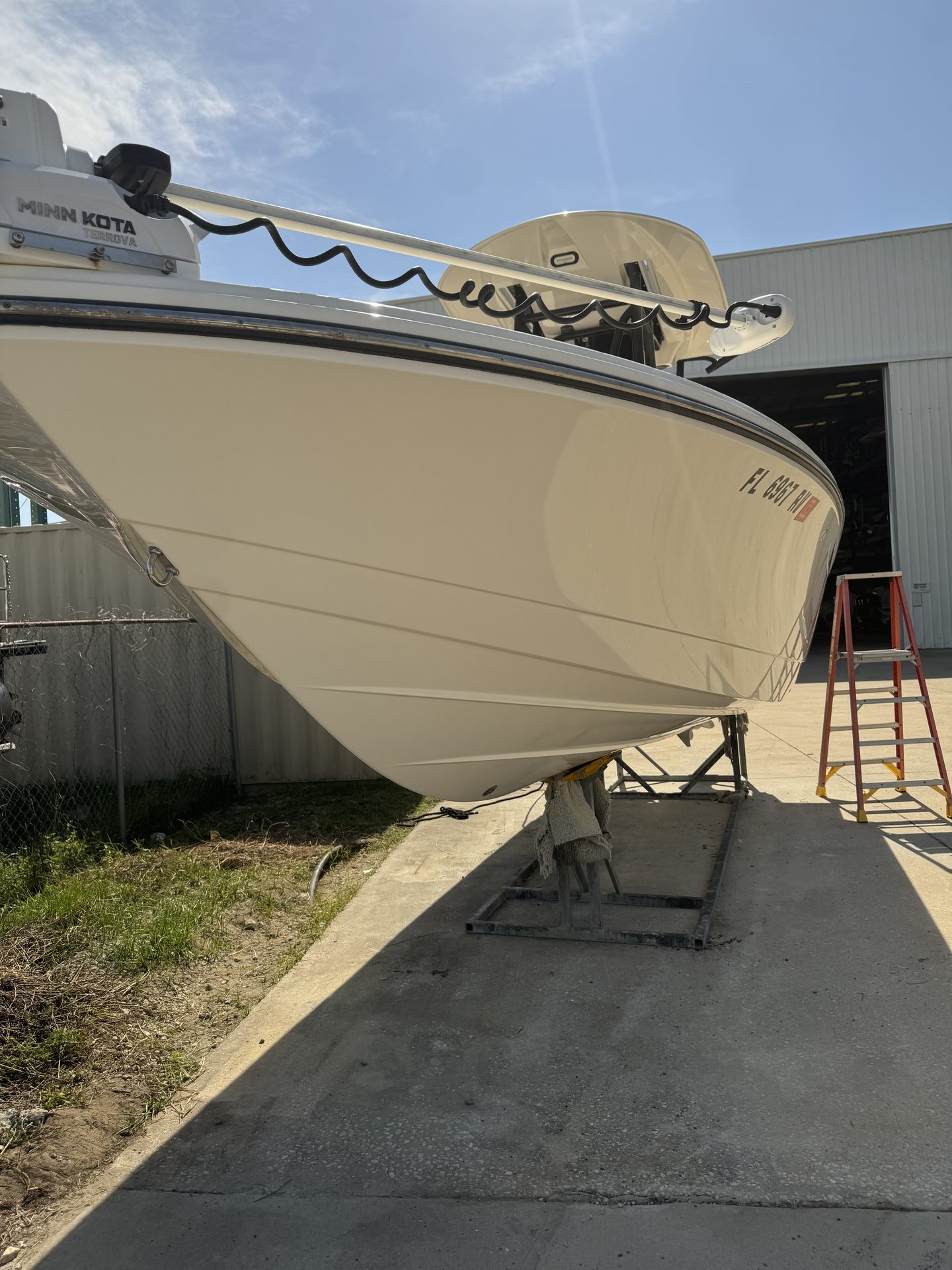 A white center console bow on stands after hull work